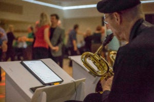 a man playing a saxophone at a dance