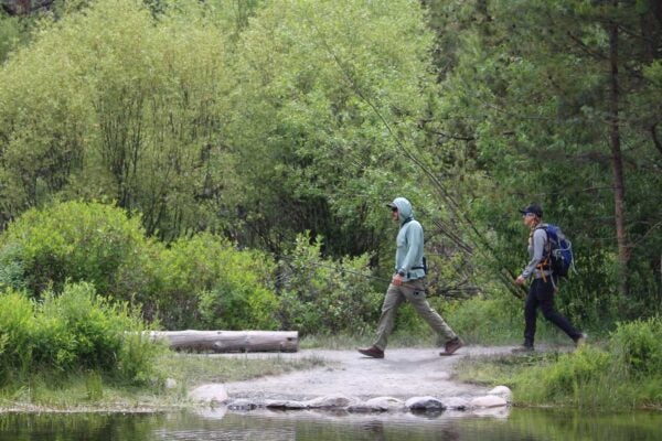 Hikers crossing Tumalo Creek in Shevlin Park