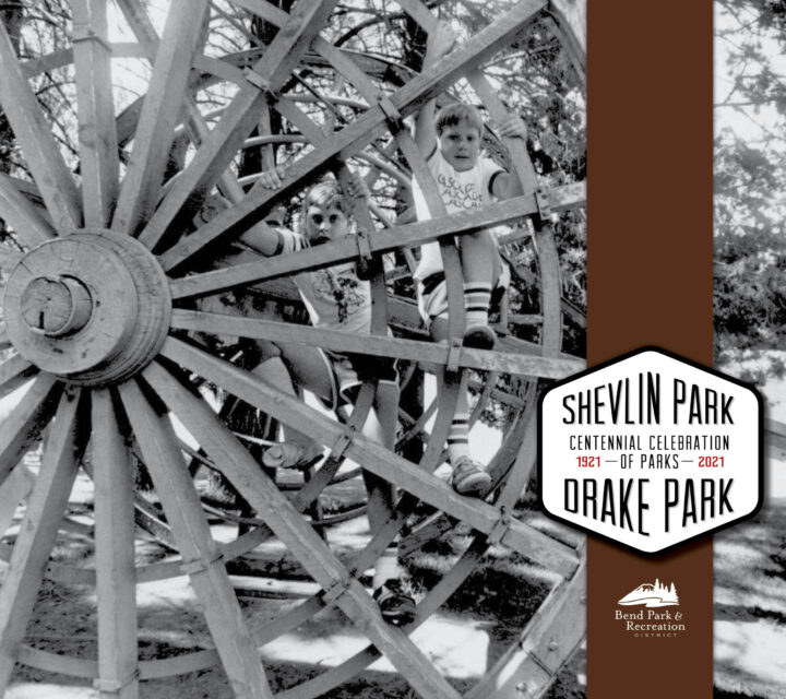 A boy playing on a wagon wheel in Drake Park.