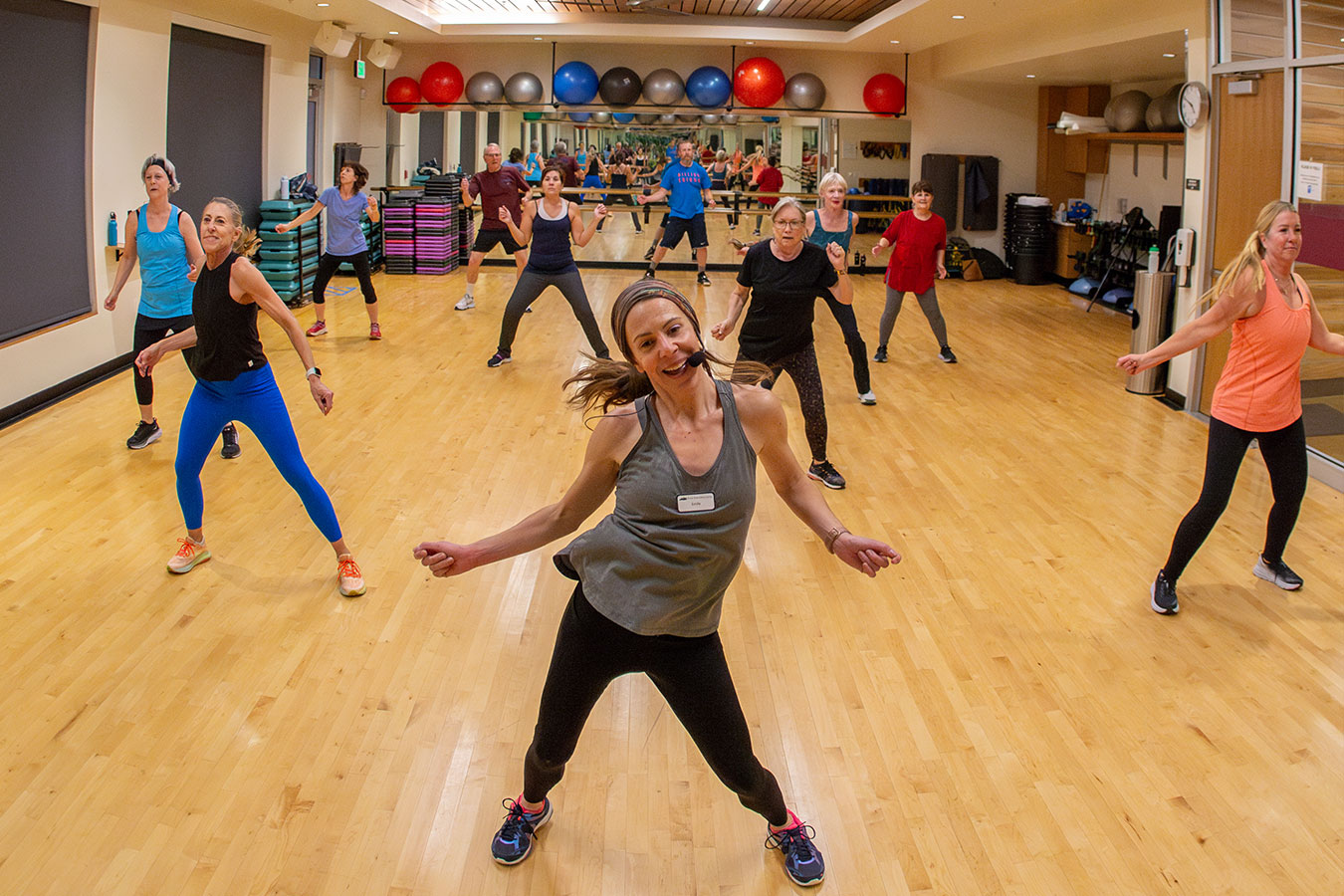 Instructor leads a group of patrons during a dance workout class.