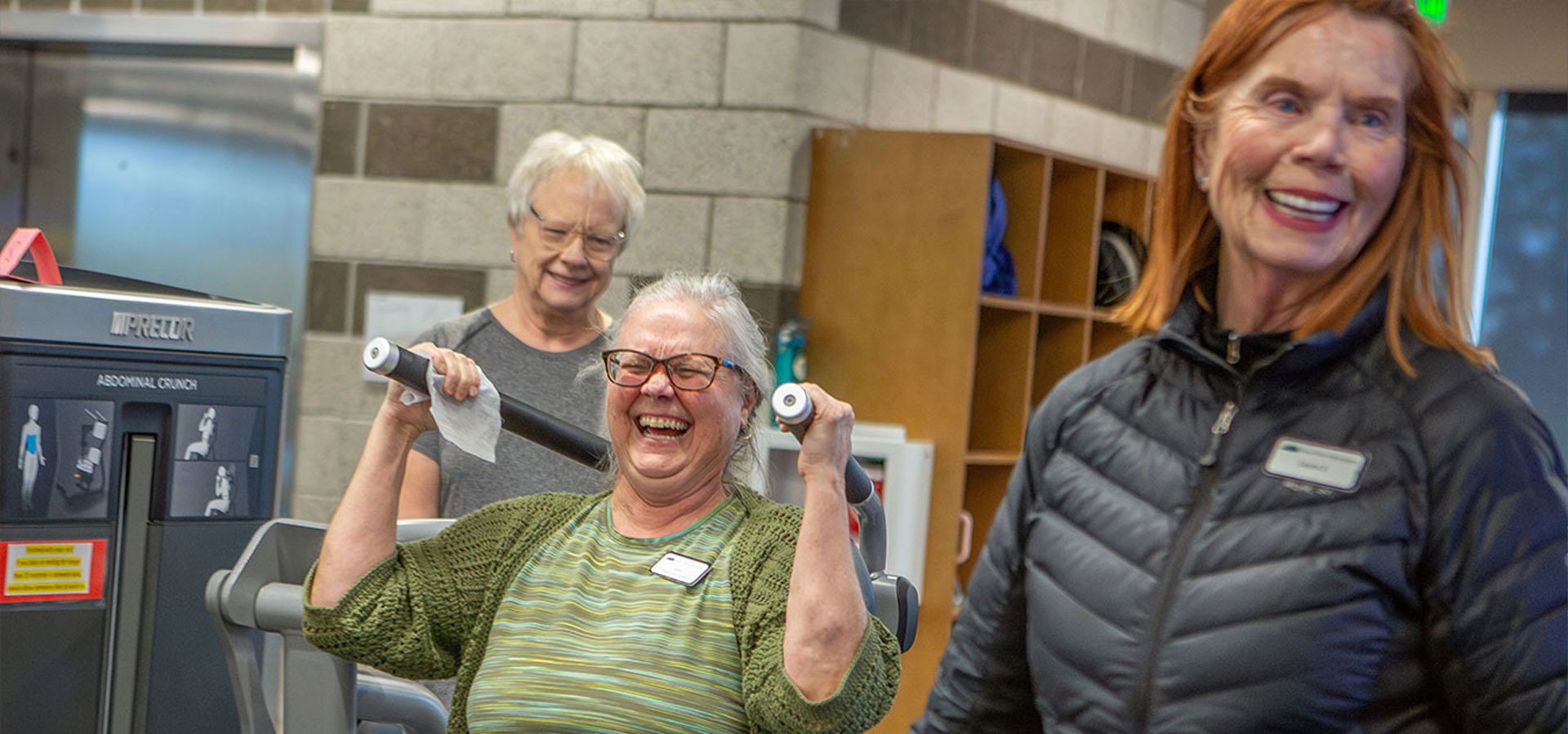 Patrons and instructor are having fun on the wight machines.
