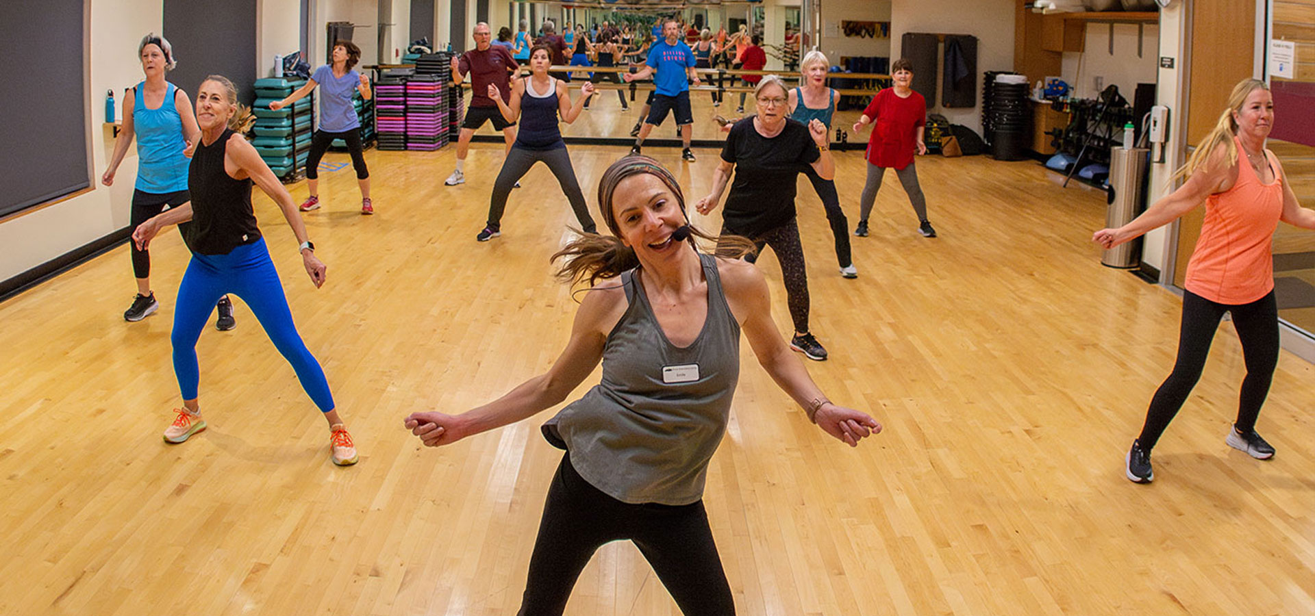 Instructor leads a group of patrons during a dance workout class.