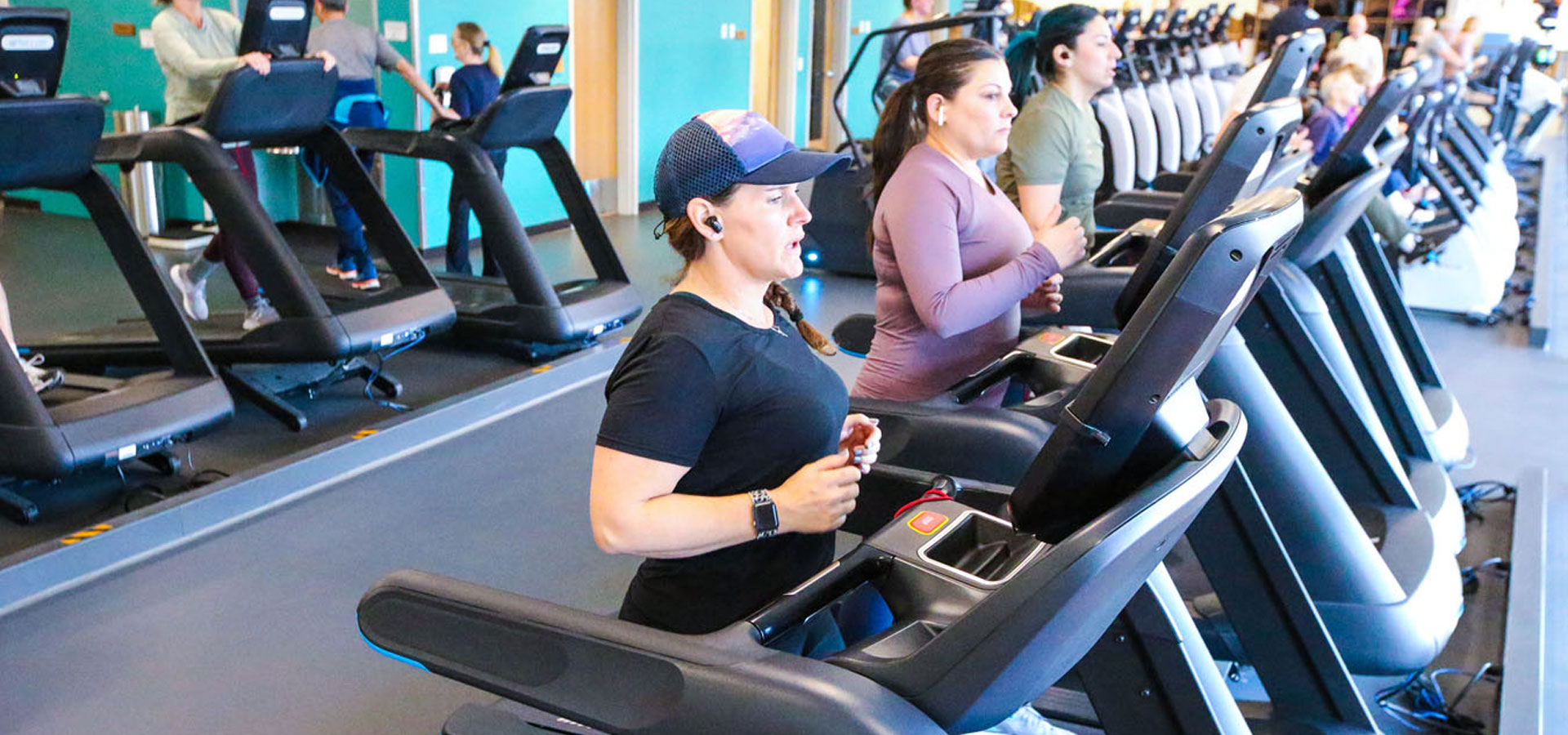 Photo of several patrons on the running machines at Larkspur.