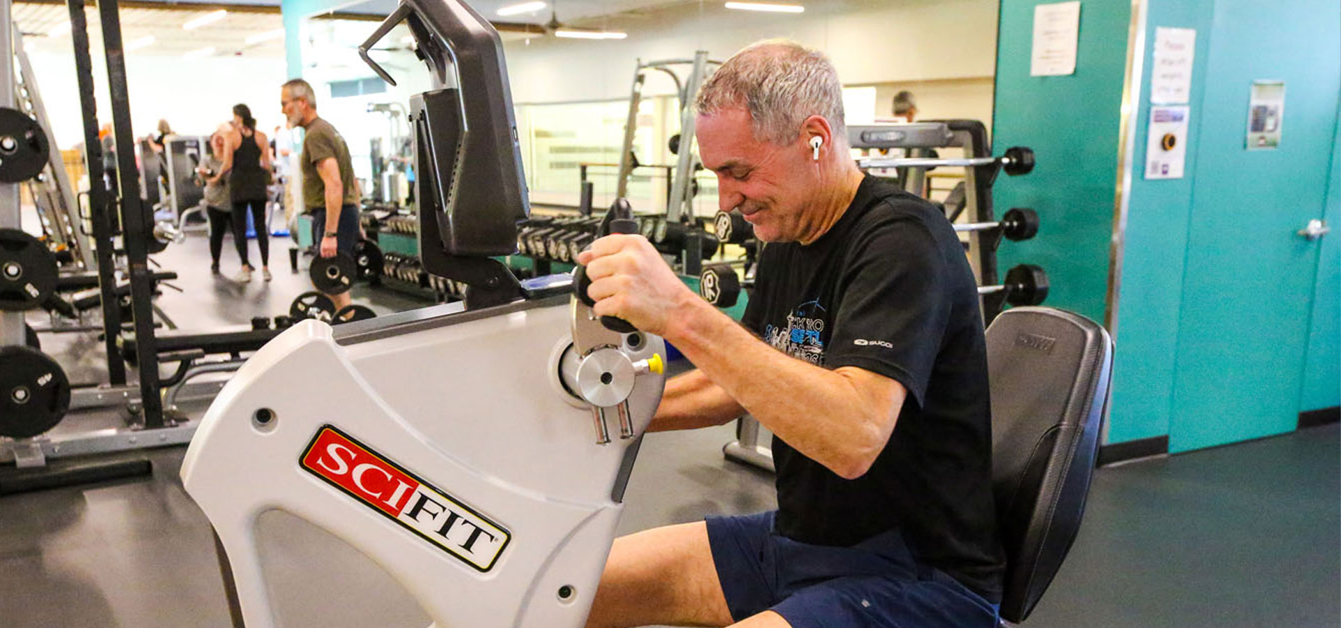 Older adult using a fitness machine at Larkspur.