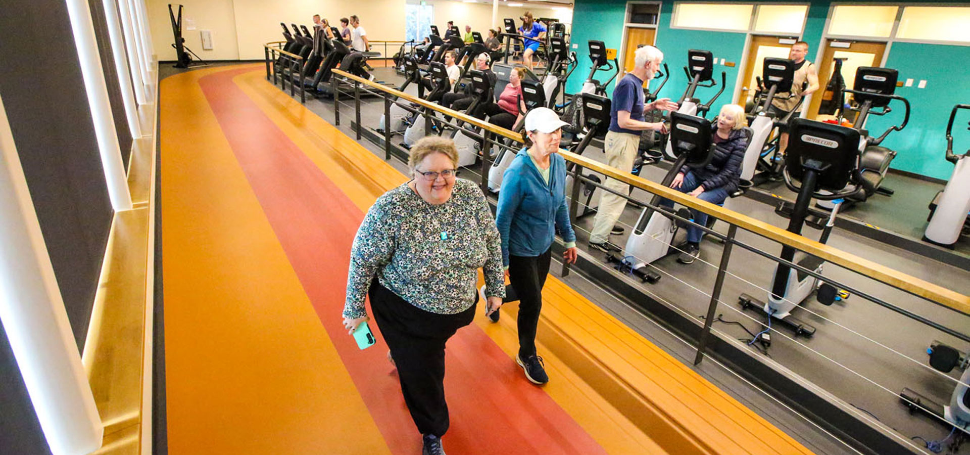 Two patrons enjoying the indoor track at Juniper.