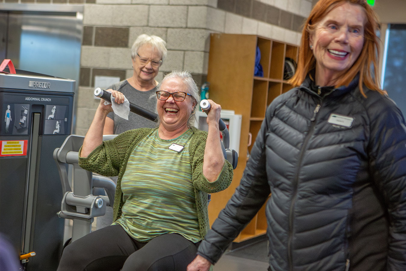 Patrons and instructor are having fun on the wight machines.
