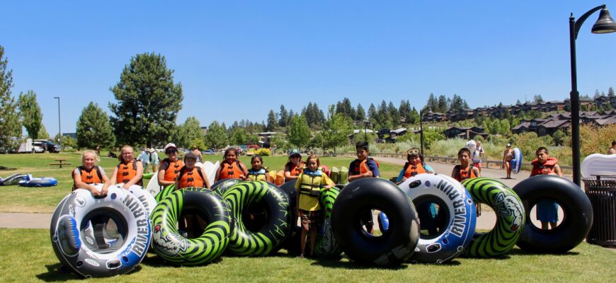 a group of kids getting ready to float the river