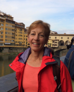 head portrait of Judith Smith personal trainer with cityscape in background