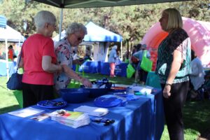 Seniors milling about in a health fair.