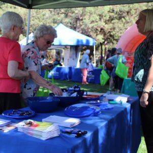 Seniors milling about in a health fair.