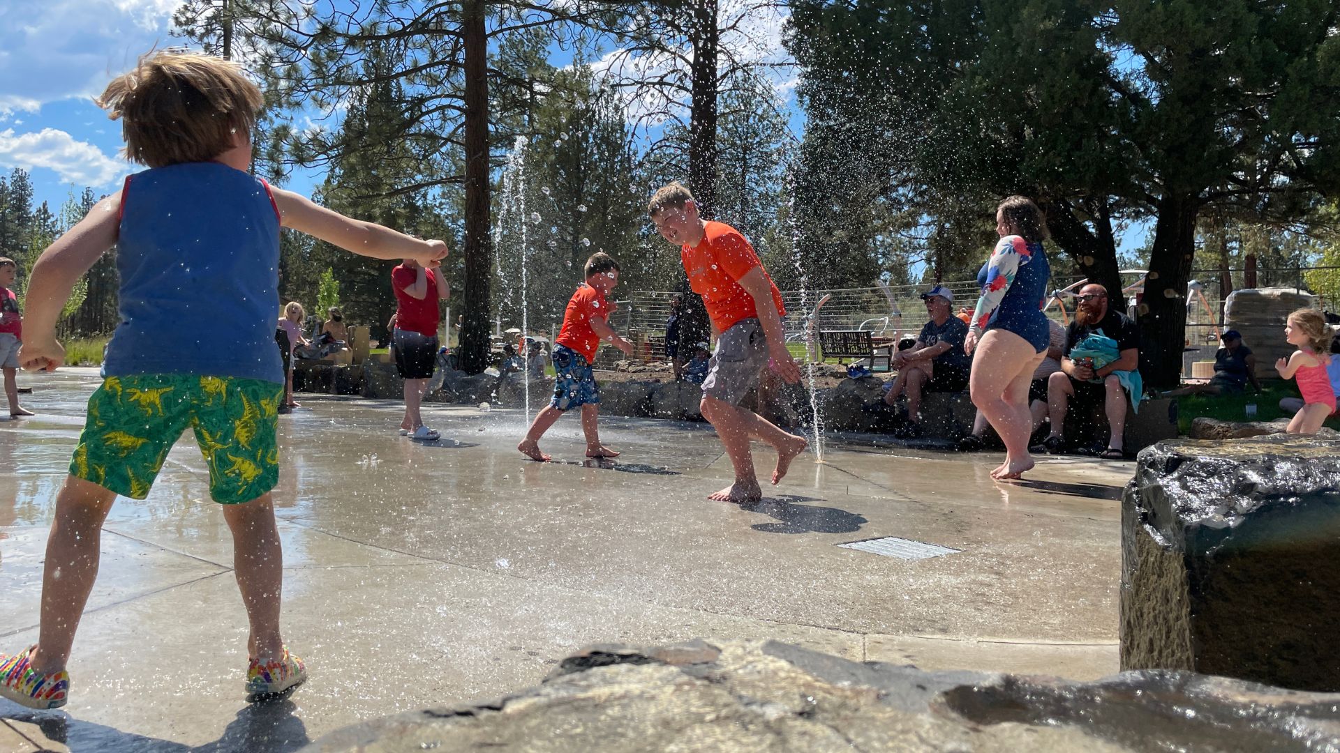 kids playing in the sprayground at alpenglow park