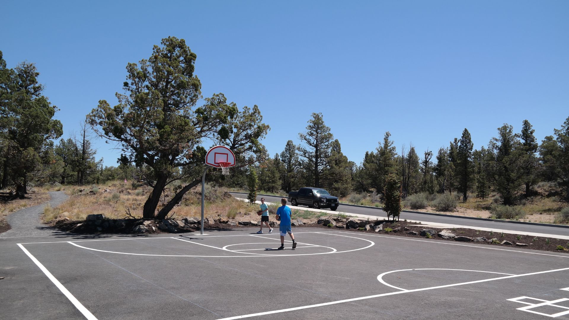 kids playing basketball outside at northpointe park in bend