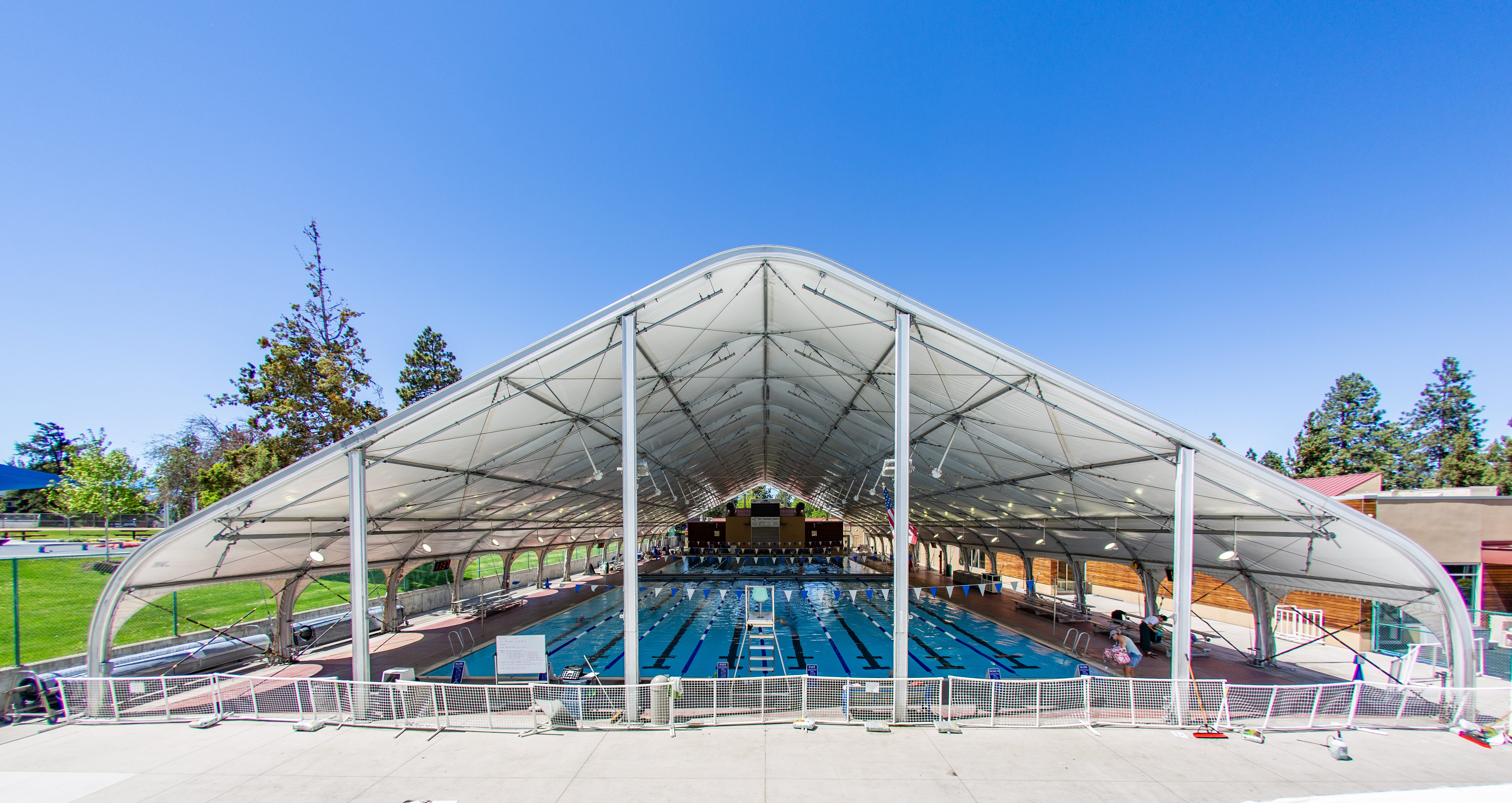 A wide photograph of the olympic size pool at Juniper