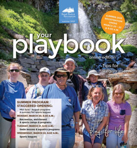 Summer 2023 Playbook cover featuring Therapeutic Recreation hiking group posing in front of waterfall with surrounding rocks and vegetation