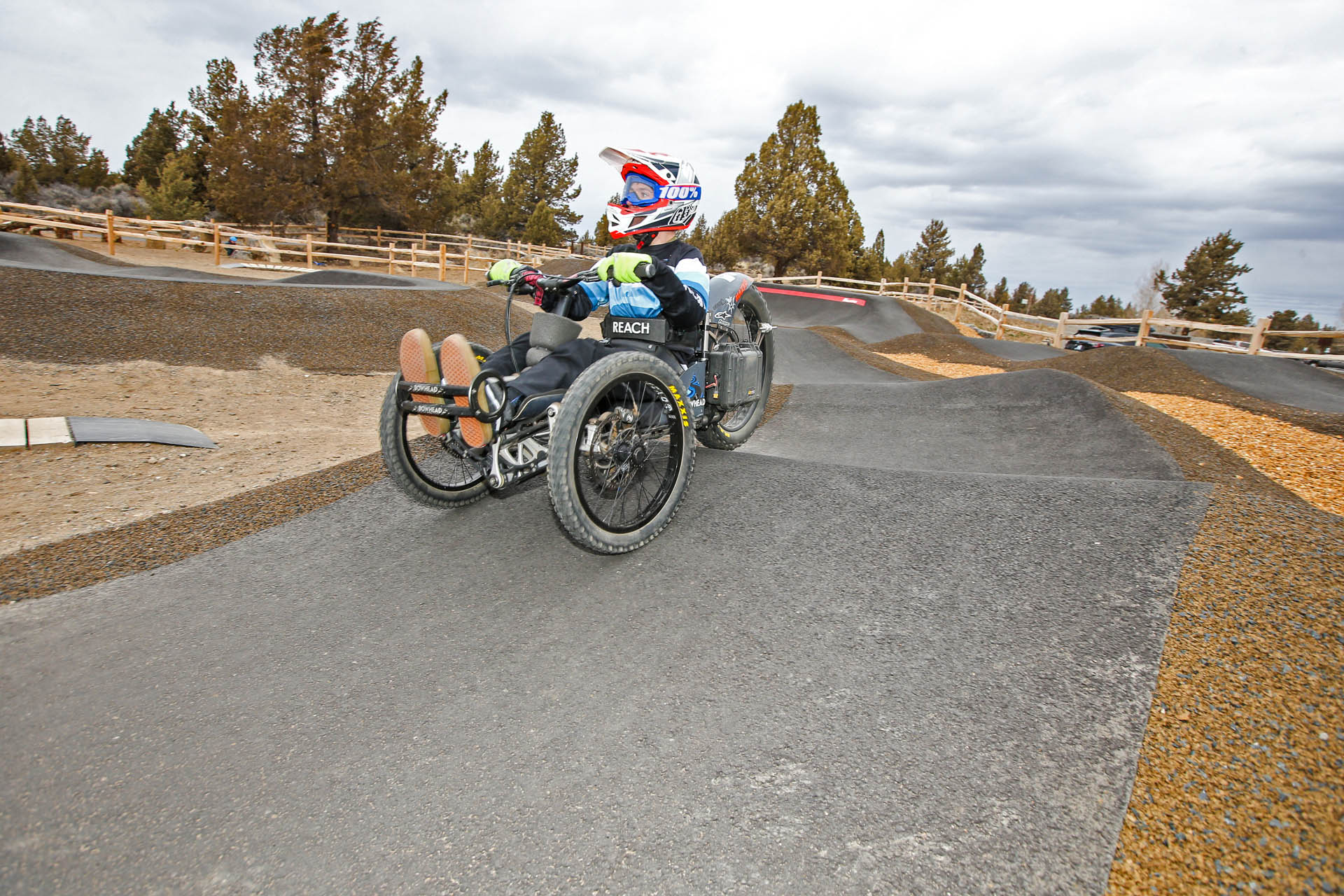 a cyclist on an adaptive bike on the pump track