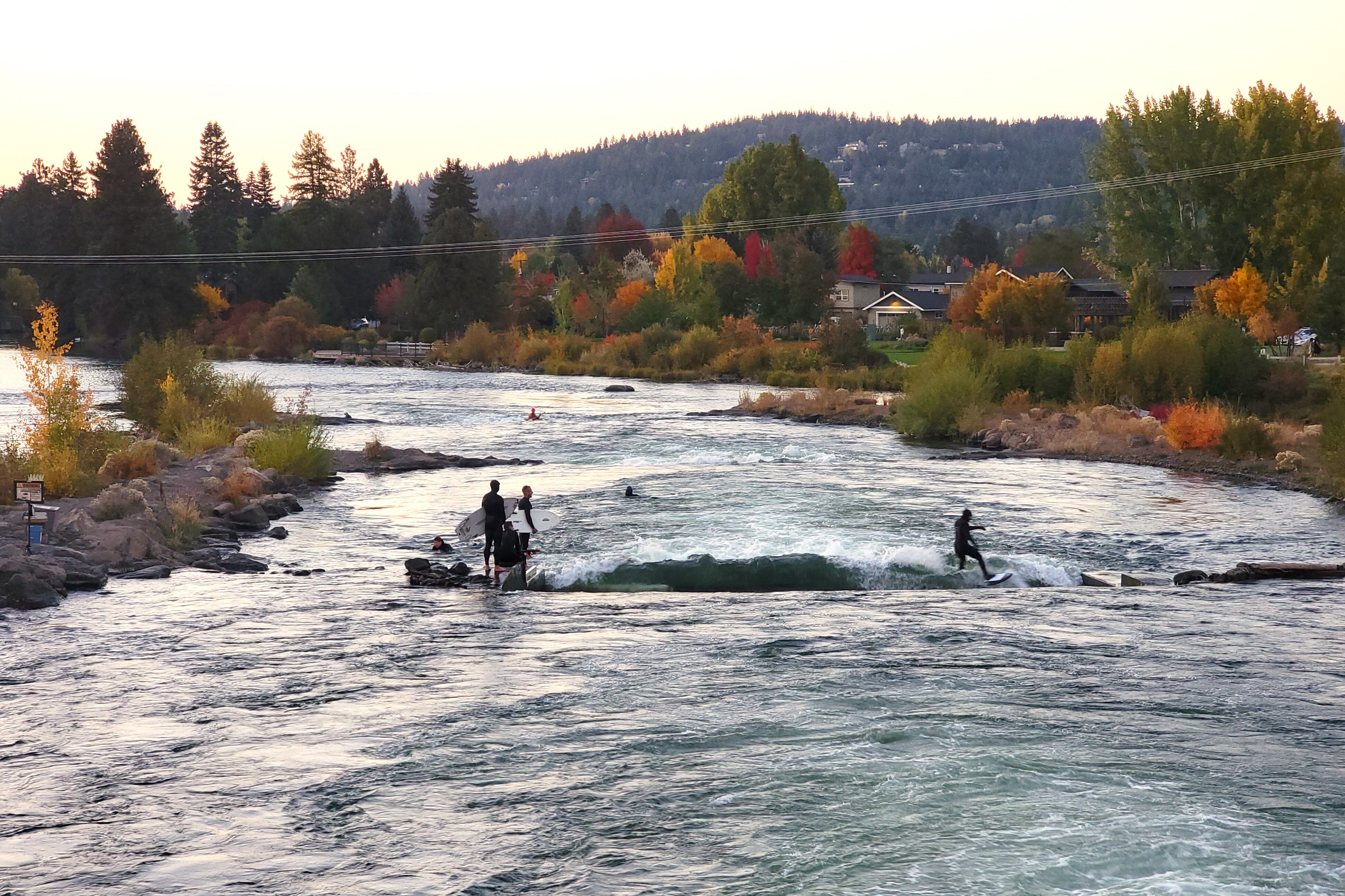 Surfers using the wave at the white water park