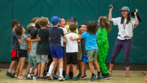 Children and recreation leader celebrate a victory at Kids Inc.