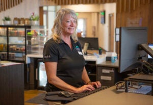 BPRD customer service staff smiling at front desk and computer