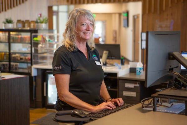 BPRD customer service staff smiling at front desk and computer