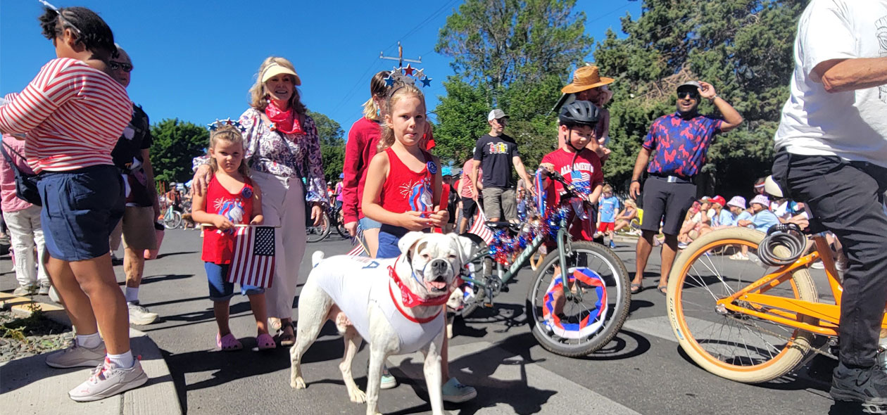 a girl and her dog and family march the parade