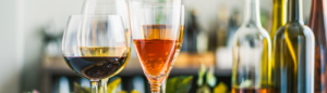 wine glasses and bottles with colorful wine