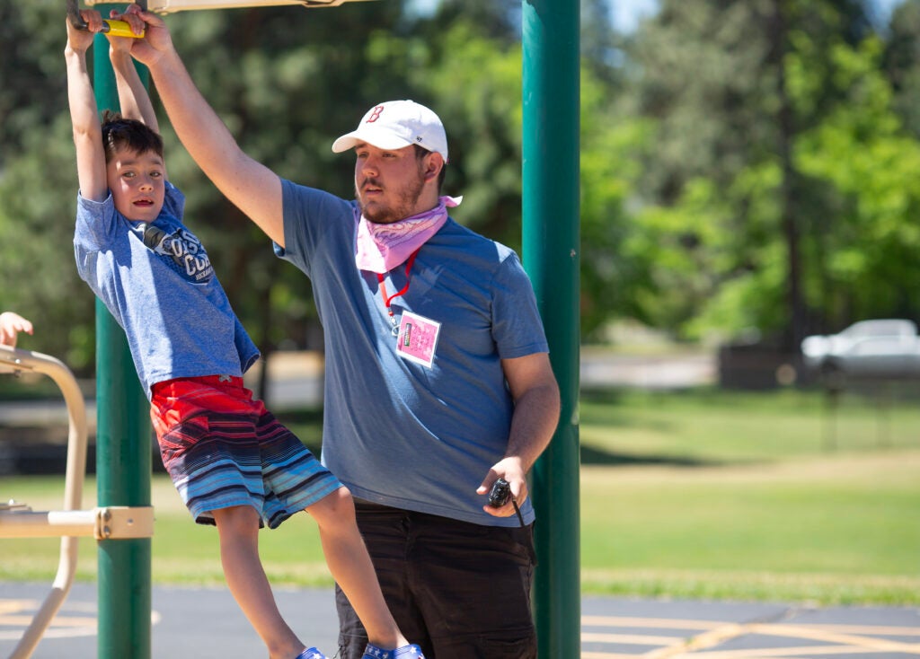 Greg Kleinhert Op Rec June 2024 (25) Youth Recreation employee aiding children at Op Rec.