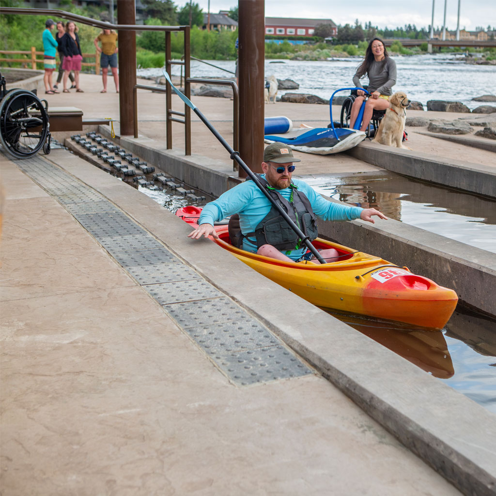 Miller's-Landing-Roller-Launch A patron using the roller launch to get their kayak in the water.