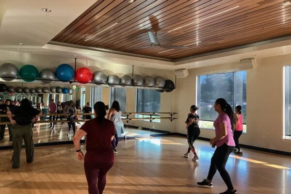 Patrons moving in a Zumba in Spanish class at Larkspur Community Center.