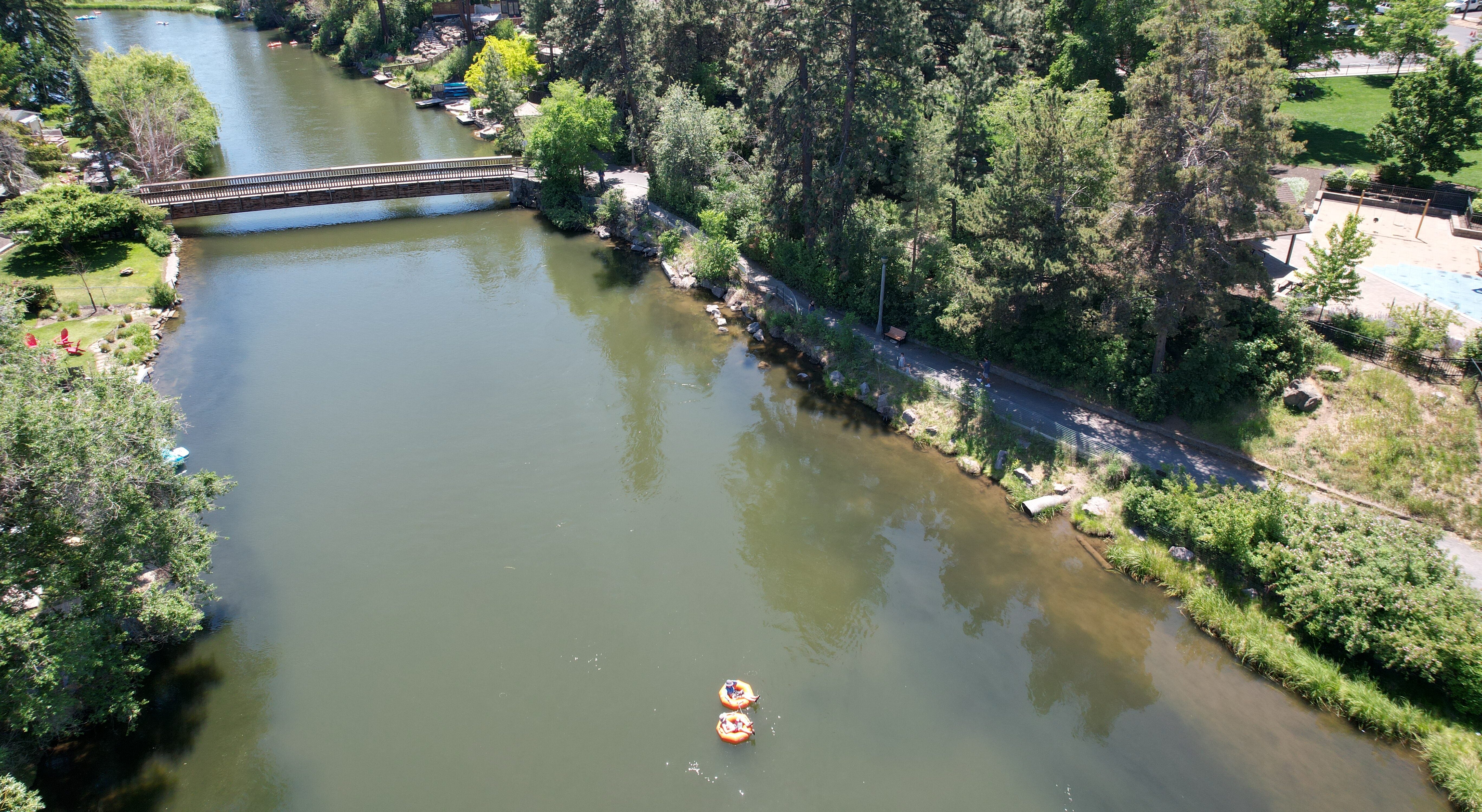 Floaters go by the Columbia park river bank