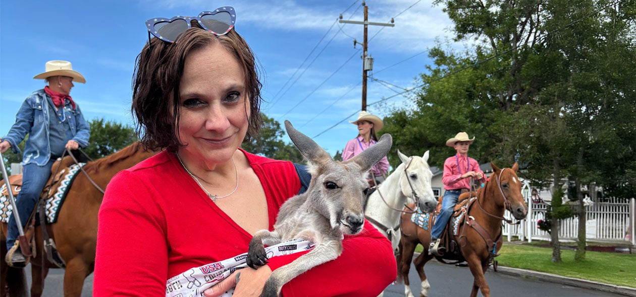A kangoroo and her owner look at the camera at the Pet Parade